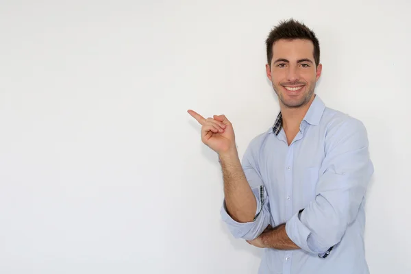 Cheerful young man showing message on whiteboard — Stock Photo, Image