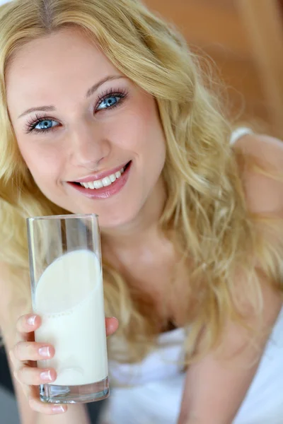 Hermosa mujer sosteniendo un vaso de leche fresca — Foto de Stock