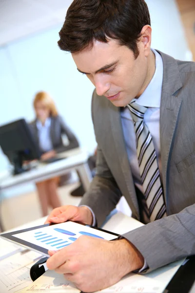 Businessman using digital tablet in office — Stock Photo, Image