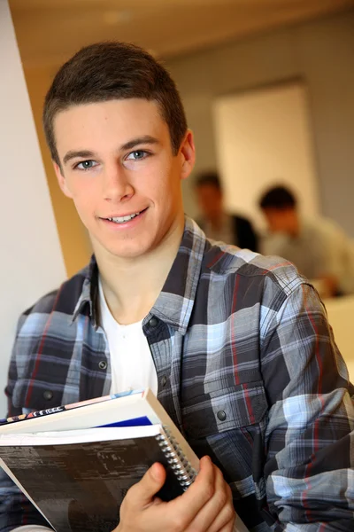 Student boy in class holding books — Stock Photo, Image