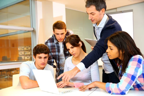 Group of students in computer training with teacher — Stock Photo, Image