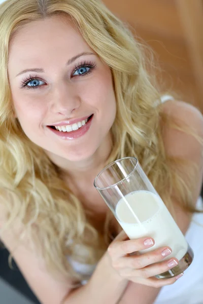 Beautiful woman holding glass of fresh milk Stock Image