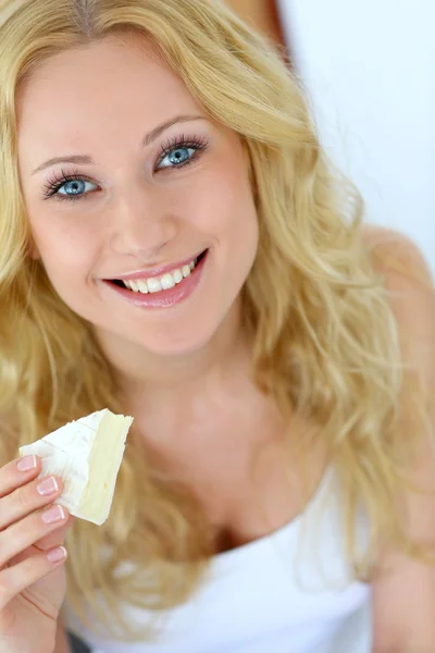 Attractive girl holding slice of french cheese Stock Picture