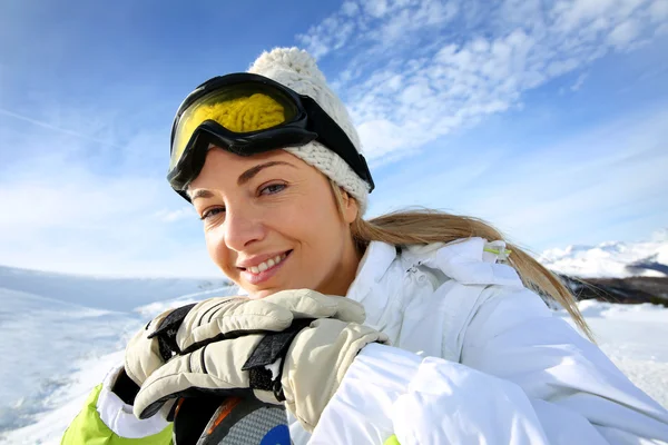 Portrait of cheerful blond woman at ski resort Royalty Free Stock Photos