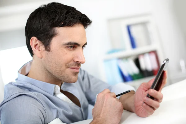 Profile view of man connected on smartphone Stock Picture