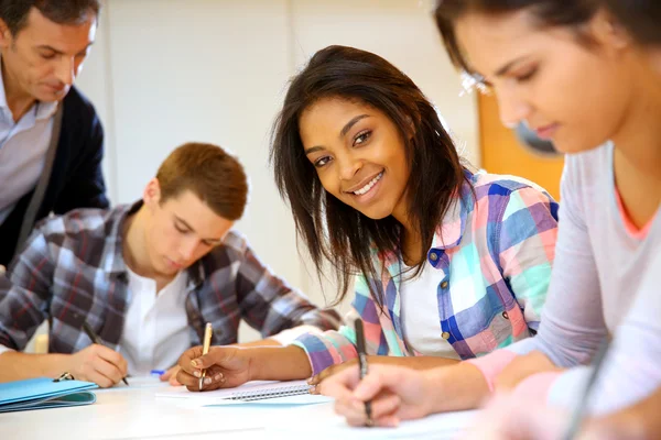 Group of teenagers in class writing an exam — Stock Photo, Image