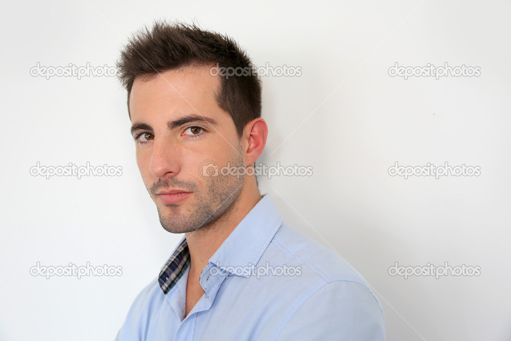 Serious young man standing on white background