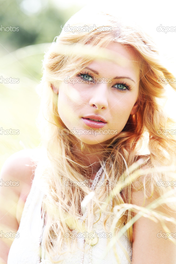Beautiful blond girl in meadow