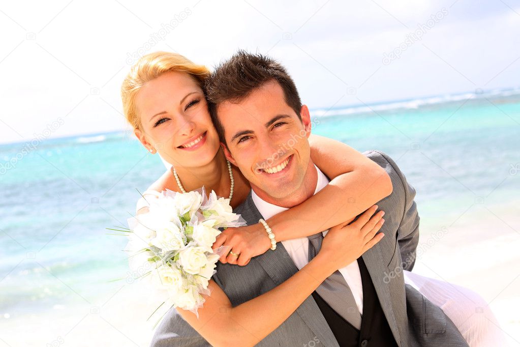 Groom holding bride on his back