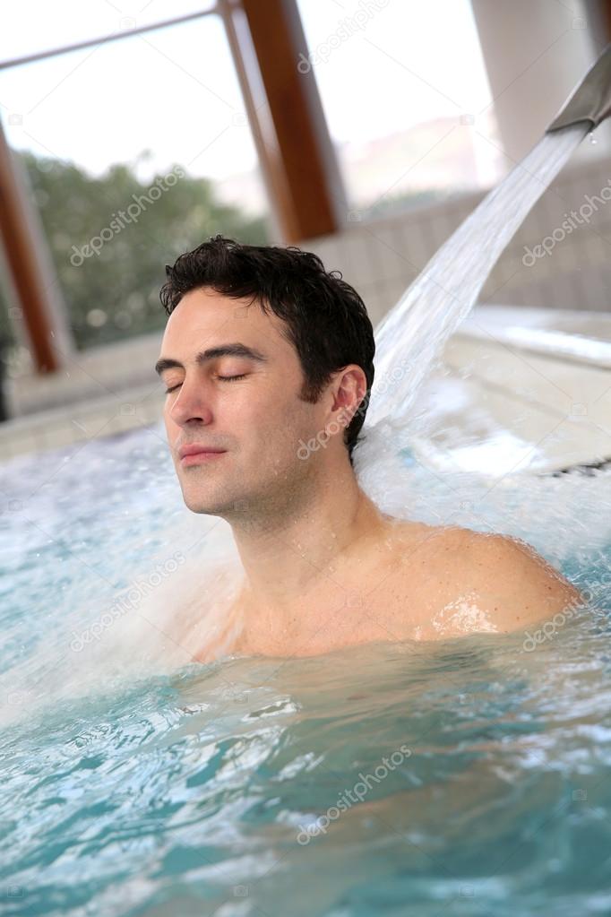 Man relaxing in massage pool