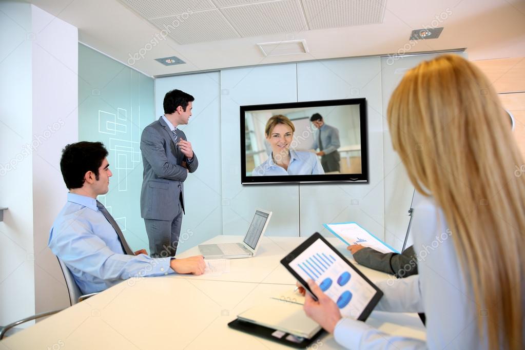 Business people attending videoconference meeting Stock Photo by