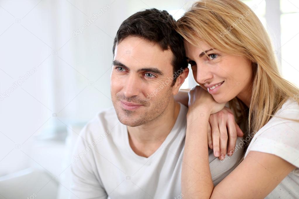 Couple embracing each other on sofa