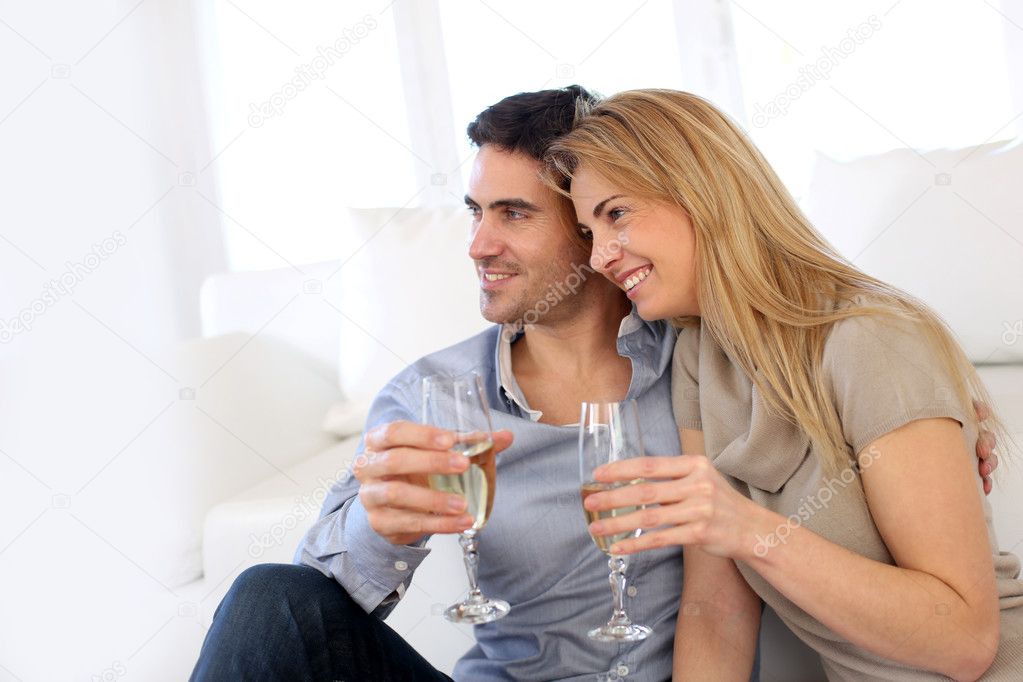 Romantic couple drinking wine at home