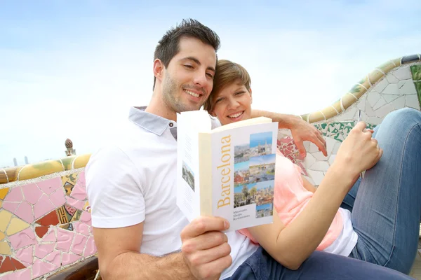 Turisták utazási olvasó könyv Güell Park, Barcelona Stock Kép