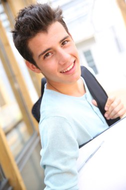Smiling high-school boy with backpack
