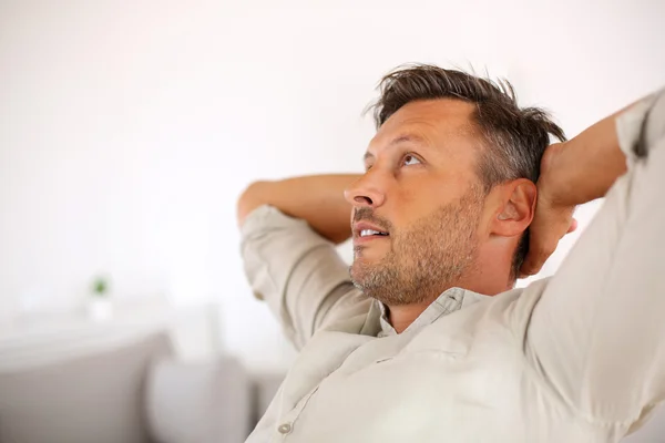 Man relaxing with outstretched arms behind head — Stock Photo, Image