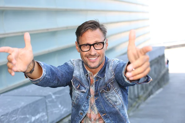 Trendy guy pointing at camera — Stock Photo, Image