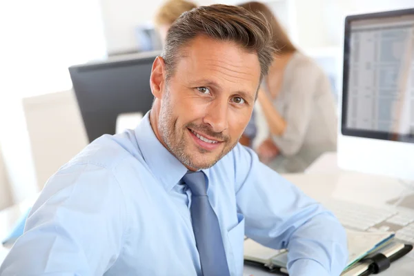 Businessman sitting in office — Stock Photo, Image