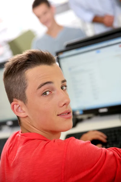 Boy sitting in front of desktop — Stock Photo, Image