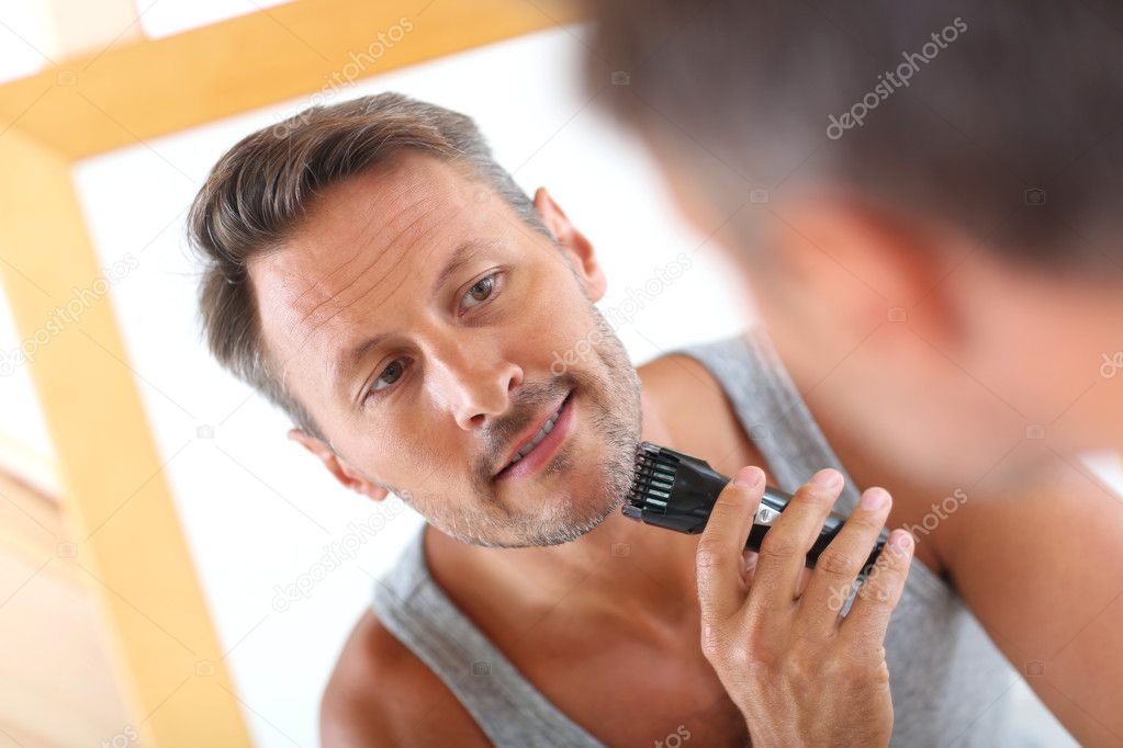 Handsome guy shaving