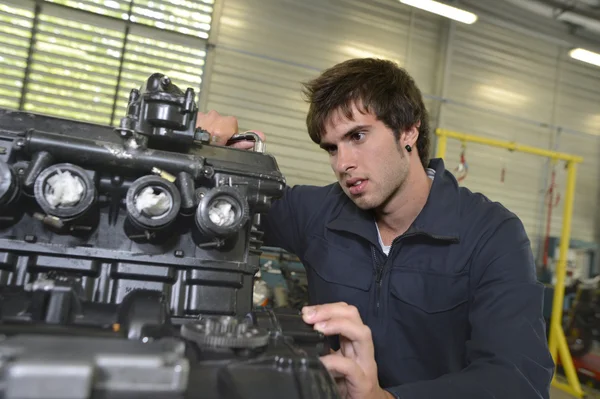 Teenager repairing motorbike — Stock Photo, Image