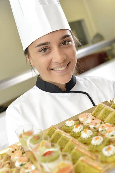 Cook holding plate of delicatessen — Stock Photo, Image