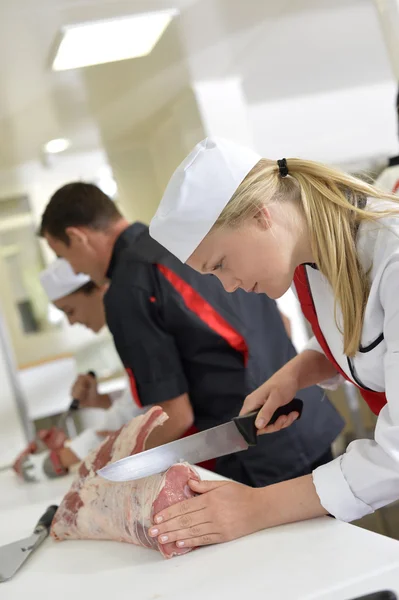 Girl cutting meat — Stock Photo, Image