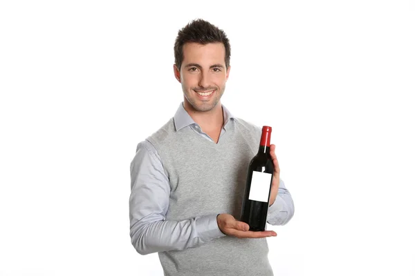 Winegrower showing wine bottle — Stock Photo, Image