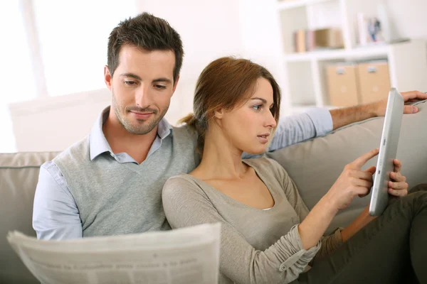 Pareja leyendo noticias tanto en prensa como en internet —  Fotos de Stock