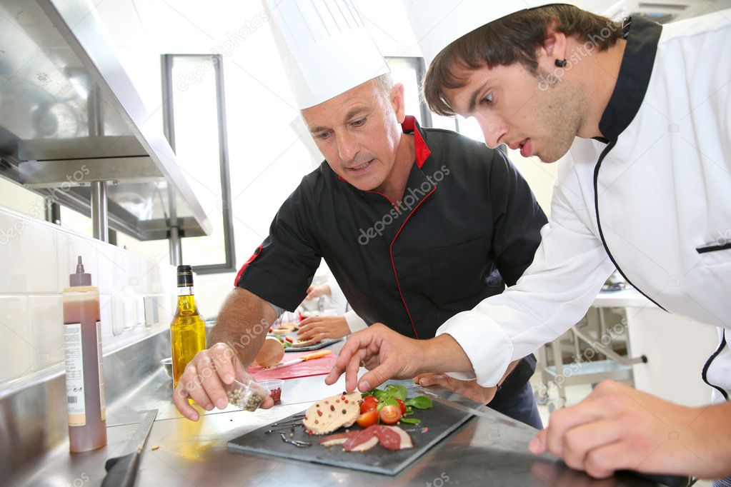 Student in catering to prepare foie gras dish