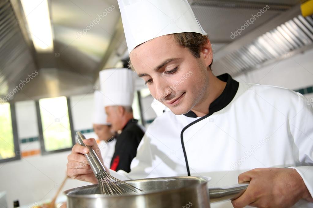 Young cook preparing sauce