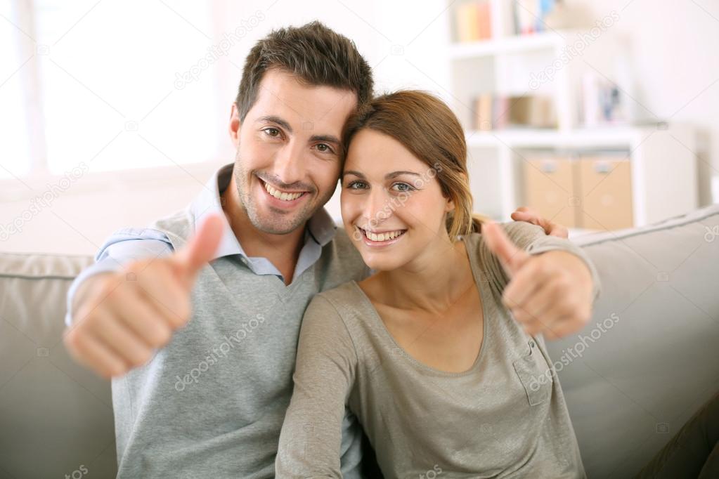 Couple showing thumbs up