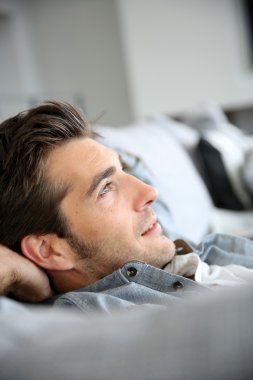 Man relaxing in sofa clipart