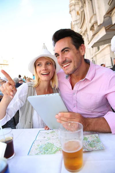 Туристи використовують планшет під час пиття — стокове фото