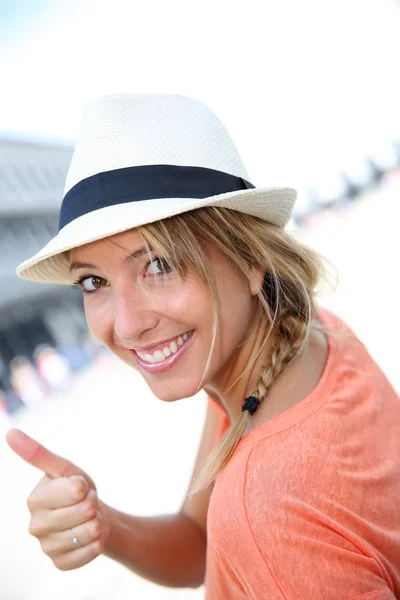 Vacker flicka med hatt visar tummen — Stockfoto