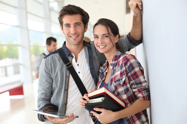 Friends standing in university hallway — Stock Photo, Image