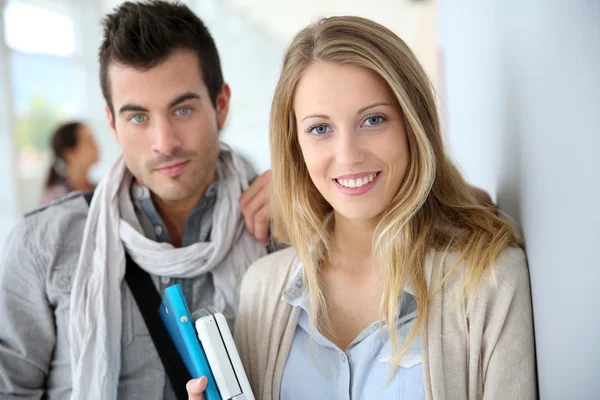 Friends standing in university hallway — Stock Photo, Image