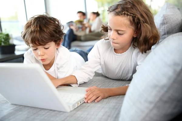 Kids playing with laptop computer — Stock Photo, Image