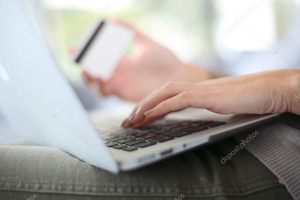 Hand holding credit card to buy online