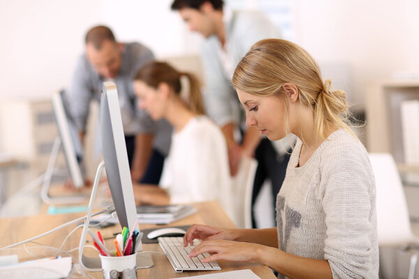 Girl in office working on desktop computer