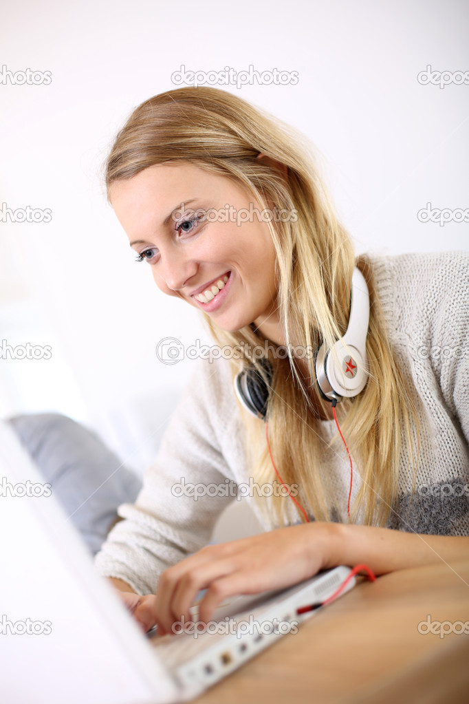 Girl sitting in class and working on laptop