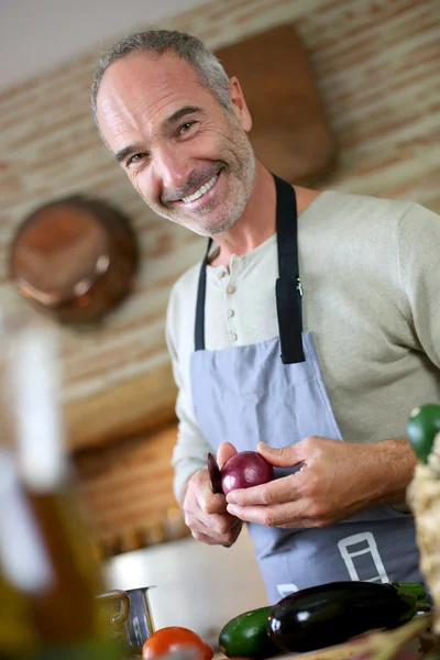 Mature handsome man cooking — Stock Photo, Image