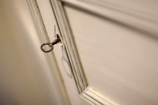 Key in wooden door lock — Stock Photo, Image