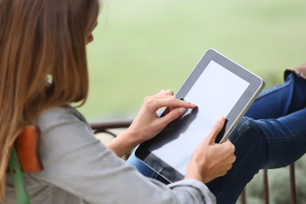Woman relaxing in chair and using tablet — Stock Photo, Image