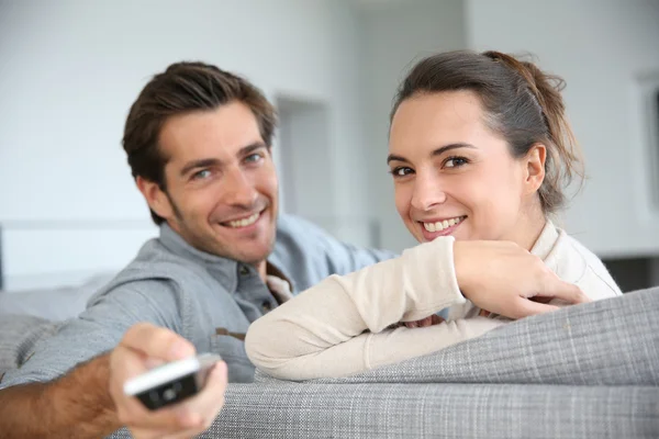 Couple with remote control — Stock Photo, Image