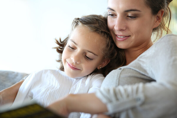 Mom and daughter reading book