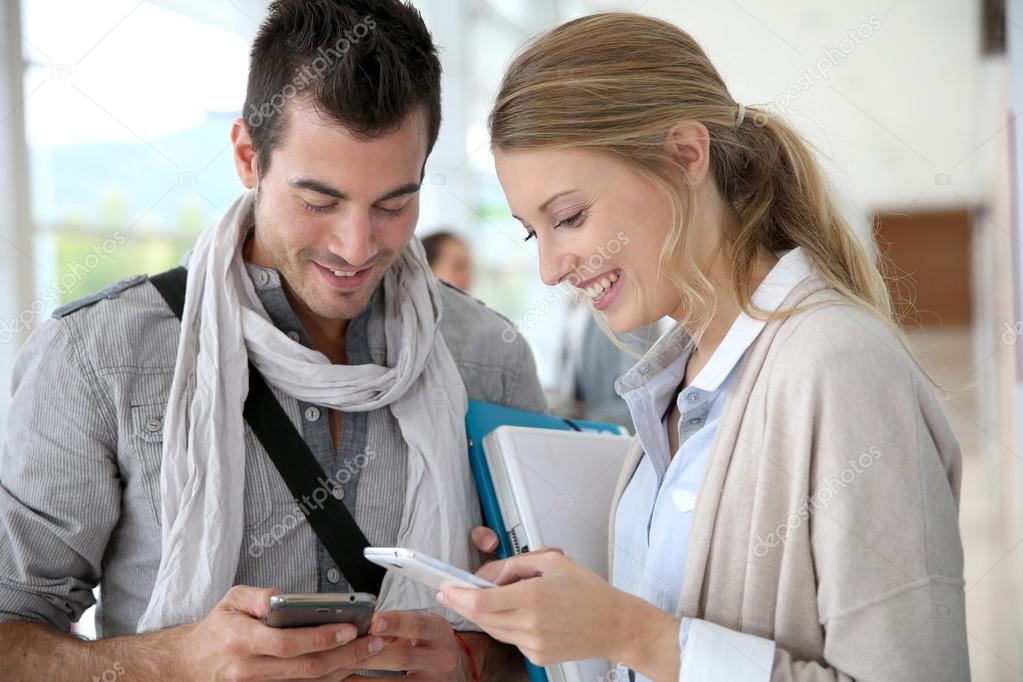 Students exchanging phone numbers