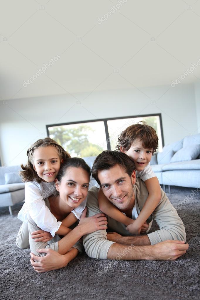 Family on carpet — Stock Photo © Goodluz 36646297
