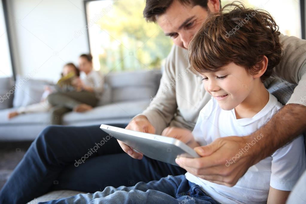 Father and son with tablet