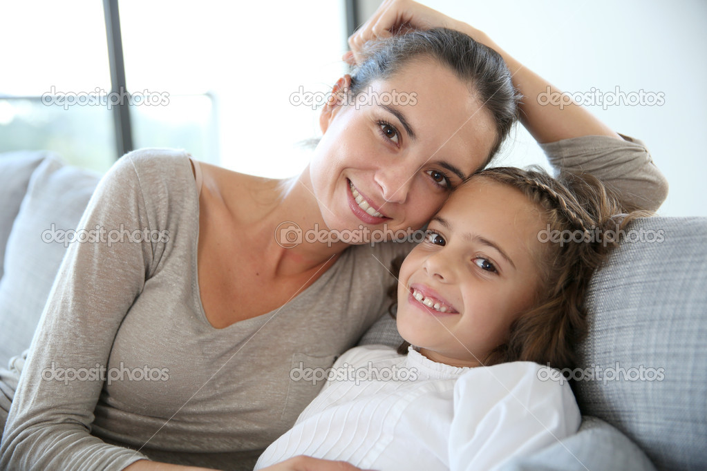 girl with mom lying in bed